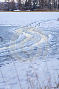Tire tracks on a frozen lake photo