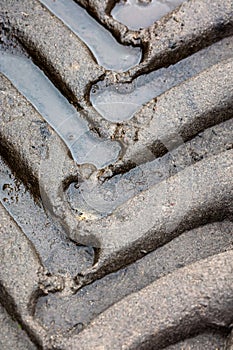 Tire tracks on muddy road in countryside closeup