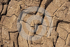 Tire tracks print on dirty red soil. Wheel marks of truck on soil texture background. Tyre track on sand texture