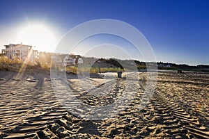 Tire tracks in the sand of the Baltic Sea beach