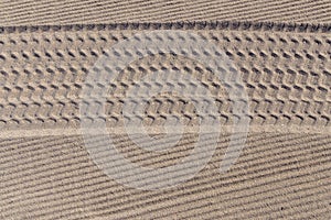 Tire tracks in the sand on the beach