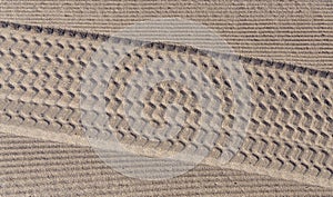 Tire tracks in the sand on the beach