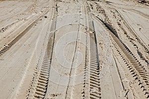 Tire tracks in the sand of a beach