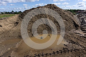 Tire tracks in the sand and gravel hills.