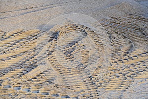 Tire tracks in the sand from a tank or excavator