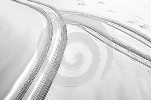 Tire tracks on a snow-covered road. Winter landscape.