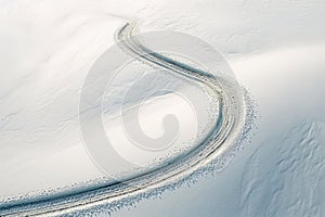 Tire tracks on a snow-covered road. Winter landscape.