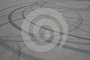 Tire tracks. wheel track on asphalt road. asphalt with traces of car wheels. Traces of braking from rubber tyres on cement. Abstra