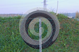 Tire on the wire mesh fence