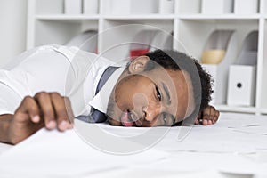 Tired African American clerk in office