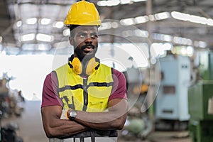 tired African American mechanical engineer worried standing by in factory. black labor worker man bored work in warehouse . male