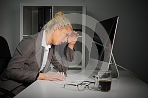 Tired and annoyed woman working on computer at the office