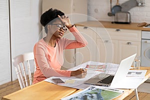 Tired architect woman work from home touch forehead. Black freelancer female suffer from headache