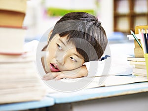 Tired asian elementary schoolboy