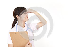 Tired Asian nurse