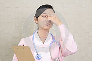 Tired Asian nurse