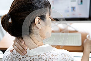 Tired asian woman with back neck and shoulders pain on muscle,stiff neck,symptom sore,painful while working,sick people have