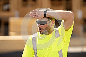 Tired bilder man in hardhat. Construction man with helmet. Industry worker at construction building. Engineer man