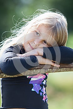 Tired blond hair small girl with clasped hands