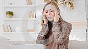 Tired blonde caucasian woman millennial busy lady exhausted freelancer sitting with laptop taking off glasses feeling