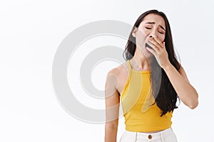 Tired or bored attractive stylish brunette east-asian woman exhausted of uninteresting conversation, falling asleep from