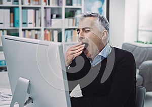 Tired bored office worker yawning