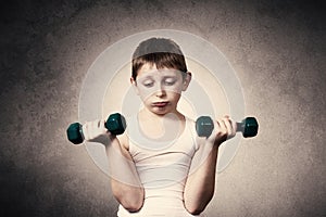 Tired,Bored,upset little boy with dumbbell.Facial expression,Sport.