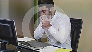 Tired bored young businessman in office