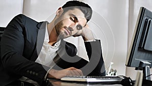 Tired bored young businessman in office