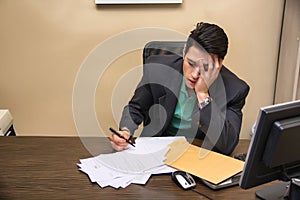 Tired bored young businessman sitting in office