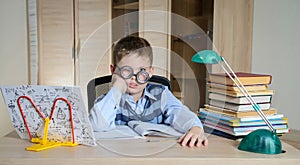 Tired Boy in Funny Glasses Doing Homework. Child With Learning Difficulties. Boy Having Problems With His Homework. Education