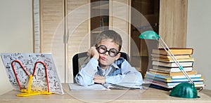 Tired Boy Wearing Funny Glasses Doing Homework. Child With Learning Difficulties. Boy Having Problems With His Homework. Education