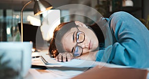 Tired, burnout and sleep with a business woman sleeping on desk while working on a computer at a desk in his office