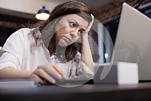 Tired business company employee sitting at desk in office workspace