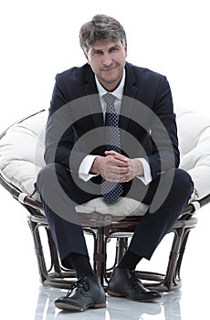 Tired business man sitting in a large comfortable chair