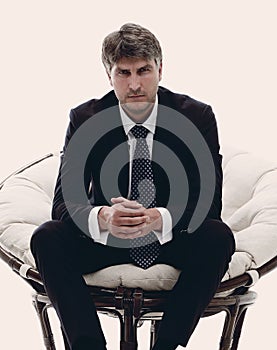 Tired business man sitting in a large comfortable chair