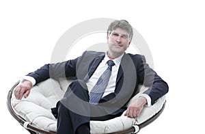 Tired business man sitting in a large comfortable chair