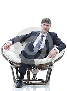 Tired business man sitting in a large comfortable chair