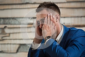 Tired business man at workplace in office holding his head on ha