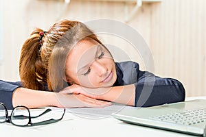 Tired business woman asleep at his desk