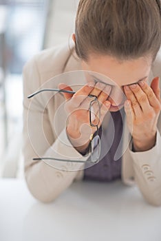 Tired business woman with eyeglasses