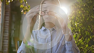 Tired business woman in glasses working with tablet at office. Portrait young Caucasian female student using wireless