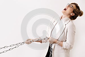 Tired business woman is pulling the chains