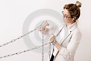 Tired business woman is pulling the chains