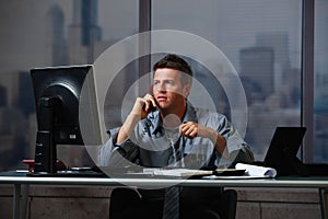 Businessman on call working overtime photo