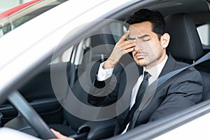 Tired Businessman Driving Car