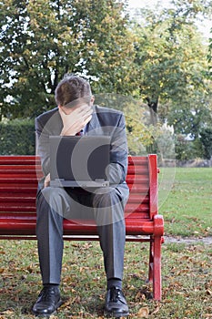 Tired businessman with laptop