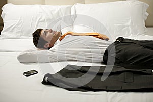 Tired Businessman Lying on Bed