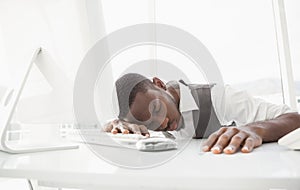 Tired businessman sleeping on keyboard