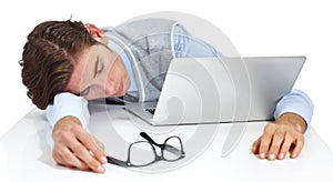 Tired businessman sleeping with laptop, white background and burnout. Fatigue, lazy and sad worker taking a nap at
